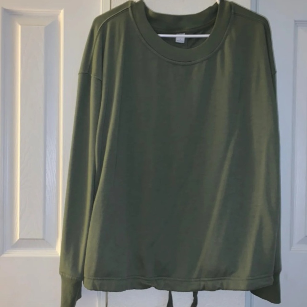 Green women’s back shown green top long sleeve